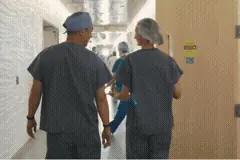 Medical staff walking a hospital hallway in a VR lecture scene